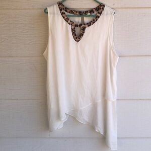 Cream asymmetrical tank top with animal print neckline and cut out features